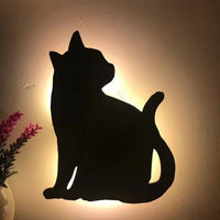 OptiLair cat-shaped wall night light with warm yellow glow and sound-sensor activation for bedroom decor.