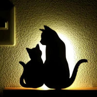 OptiLair cat-shaped acrylic night light with warm yellow glow and sound-sensor activation for bedroom decor