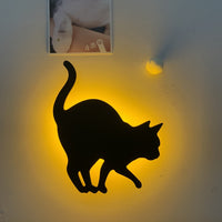 OptiLair cat-shaped wall night light with warm yellow glow and sound-sensor activation for bedroom decor