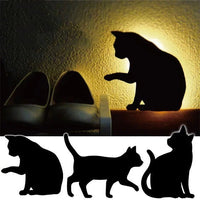 OptiLair cat-shaped acrylic night light with sound-sensor technology casting a warm silhouette on a bedroom wall.