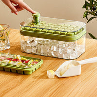 OptiLair green one-touch ice cube tray and storage box with lid and shovel on a wooden table
