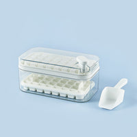 OptiLair white plastic ice cube tray with one-touch release mechanism, storage box, lid, and scoop on blue background