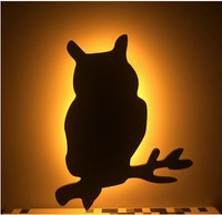 OptiLair owl-shaped wall night light with warm yellow glow and sound-sensor activation for bedroom decor
