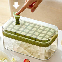 OptiLair green one-touch press ice cube tray with storage box and lid for easy release in a modern kitchen